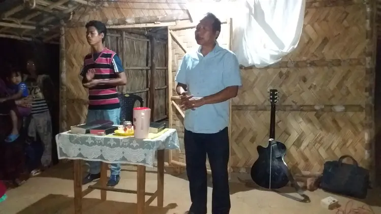 Mr. Sunmith G. Momin praying for the needy at Tebonggre village